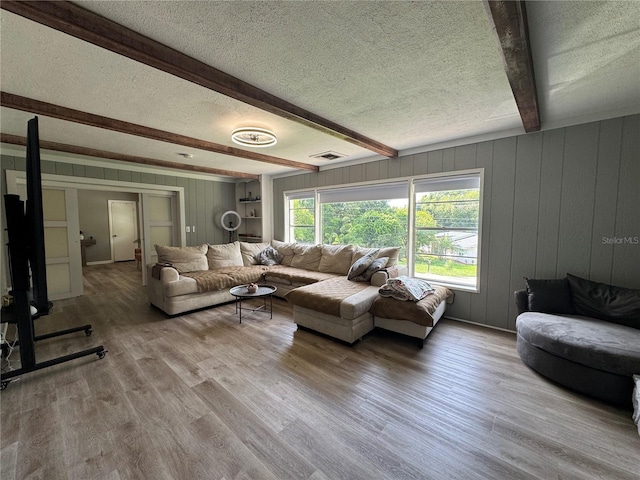 3702 Mirror Lake Dr, Apopka, FL 32703 - living room with a textured ceiling, beamed ceiling, wood finished floors, and wood walls