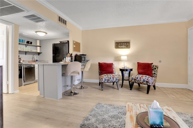 145 Oyster Bay Cir Unit 140, Altamonte Springs, FL 32701 - kitchen with stainless steel appliances, open shelves, light wood-style floors, a kitchen breakfast bar, and ornamental molding