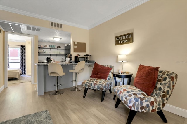 145 Oyster Bay Cir Unit 140, Altamonte Springs, FL 32701 - living area featuring light wood-type flooring, ornamental molding, and baseboards