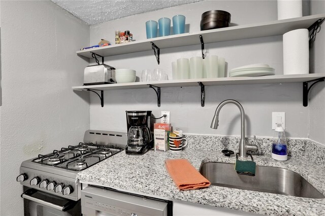 145 Oyster Bay Cir Unit 140, Altamonte Springs, FL 32701 - kitchen featuring open shelves, gas range, a sink, dishwasher, and light stone counters