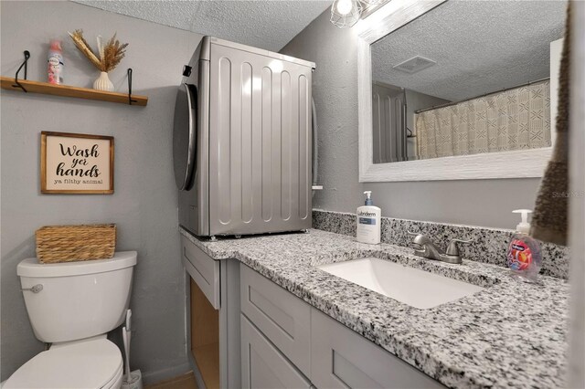145 Oyster Bay Cir Unit 140, Altamonte Springs, FL 32701 - bathroom featuring vanity, toilet, and a textured ceiling
