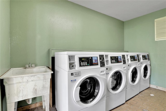 145 Oyster Bay Cir Unit 140, Altamonte Springs, FL 32701 - community laundry room featuring washer and clothes dryer and baseboards