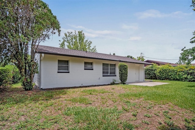 418 Tulane Dr, Altamonte Springs, FL 32714 - rear view of house with a patio, a yard, concrete block siding, and a shingled roof
