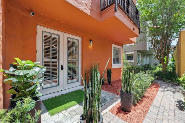 602 E Livingston St Unit 3, Orlando, FL 32803 - property entrance featuring french doors, a balcony, stucco siding, and a security system