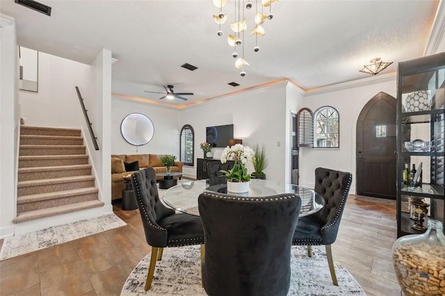 602 E Livingston St Unit 3, Orlando, FL 32803 - dining space featuring arched walkways, healthy amount of natural light, stairway, ornamental molding, and ceiling fan