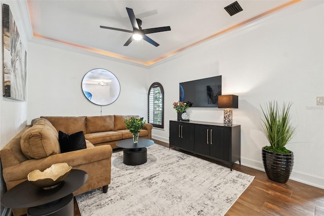 602 E Livingston St Unit 3, Orlando, FL 32803 - living room featuring a ceiling fan, wood finished floors, a tray ceiling, baseboards, and crown molding