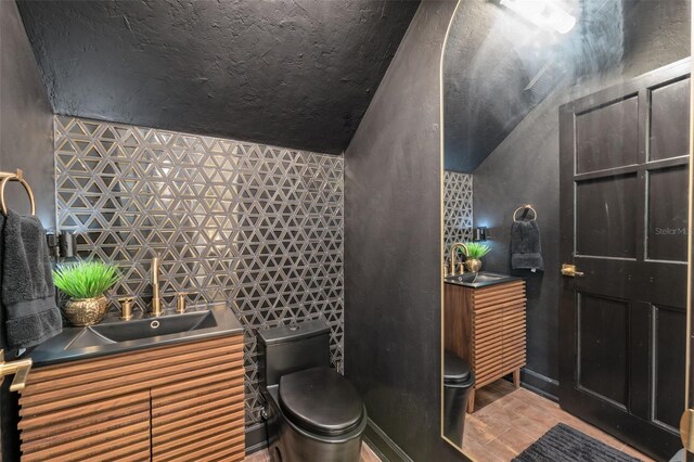 602 E Livingston St Unit 3, Orlando, FL 32803 - bathroom with lofted ceiling, toilet, a sink, and wood finished floors