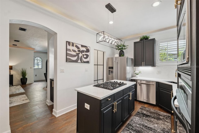 602 E Livingston St Unit 3, Orlando, FL 32803 - kitchen with appliances with stainless steel finishes, crown molding, baseboards, light countertops, and arched walkways