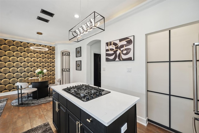 602 E Livingston St Unit 3, Orlando, FL 32803 - kitchen featuring black gas cooktop, dark cabinets, arched walkways, light countertops, and a kitchen island