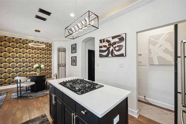 602 E Livingston St Unit 3, Orlando, FL 32803 - kitchen with black gas stovetop, dark cabinets, arched walkways, crown molding, and a kitchen island