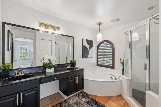 602 E Livingston St Unit 3, Orlando, FL 32803 - full bathroom featuring double vanity, a stall shower, a garden tub, and tile patterned flooring