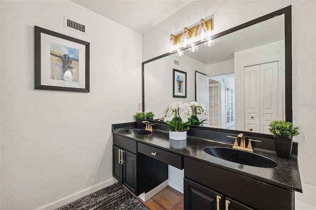 602 E Livingston St Unit 3, Orlando, FL 32803 - bathroom featuring double vanity, wood finished floors, and baseboards