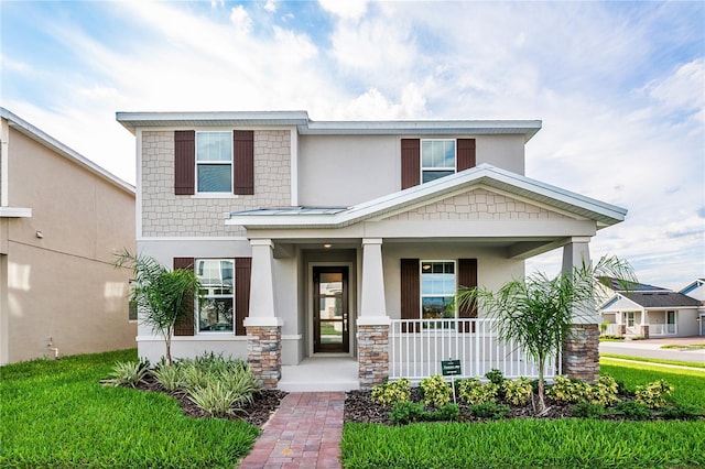 9106 Cut Shot Dr, Winter Garden, FL 34787 - view of front of property with a porch, stucco siding, and stone siding