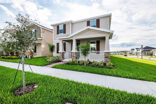 9106 Cut Shot Dr, Winter Garden, FL 34787 - view of front of house featuring stone siding, covered porch, a front lawn, and stucco siding