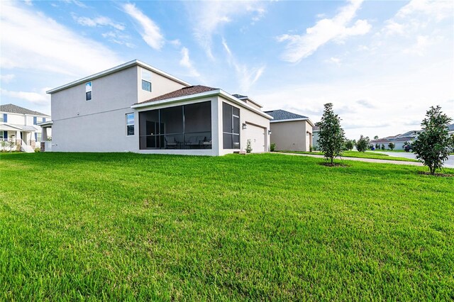 9106 Cut Shot Dr, Winter Garden, FL 34787 - back of property with stucco siding, an attached garage, a sunroom, and a yard