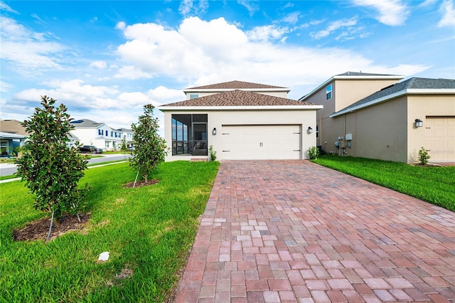 9106 Cut Shot Dr, Winter Garden, FL 34787 - view of front of property with decorative driveway, a front lawn, a sunroom, an attached garage, and stucco siding