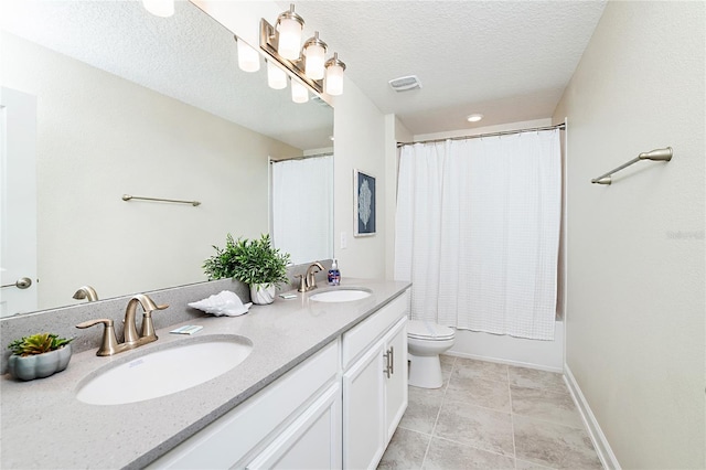 9106 Cut Shot Dr, Winter Garden, FL 34787 - full bathroom featuring double vanity, toilet, shower / tub combo, a textured ceiling, and baseboards