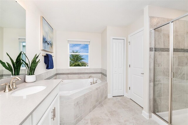 9106 Cut Shot Dr, Winter Garden, FL 34787 - bathroom featuring vanity, a shower stall, a garden tub, and tile patterned floors