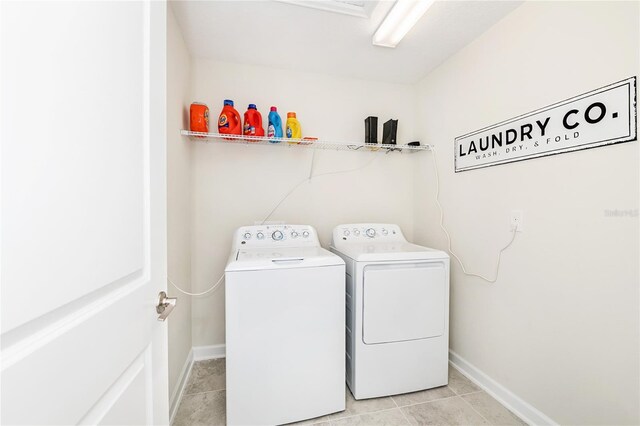 9106 Cut Shot Dr, Winter Garden, FL 34787 - washroom with independent washer and dryer, baseboards, and light tile patterned floors