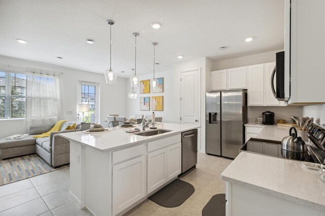 746 Longboat Dr, Davenport, FL 33896 - kitchen with appliances with stainless steel finishes, white cabinets, pendant lighting, an island with sink, and recessed lighting