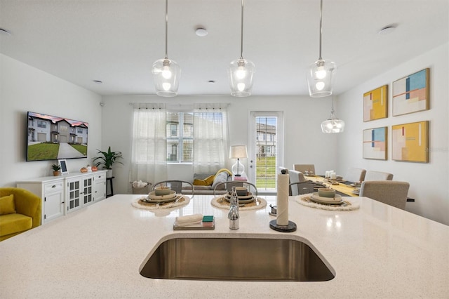 746 Longboat Dr, Davenport, FL 33896 - kitchen with open floor plan, pendant lighting, and light stone countertops