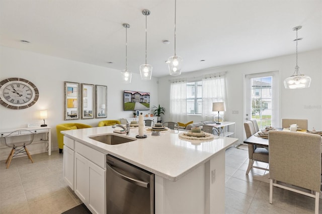 746 Longboat Dr, Davenport, FL 33896 - kitchen with stainless steel dishwasher, open floor plan, light tile patterned flooring, and a center island with sink
