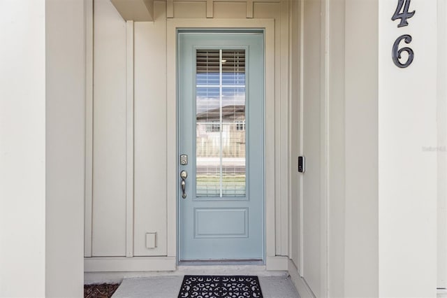 746 Longboat Dr, Davenport, FL 33896 - doorway to property featuring board and batten siding