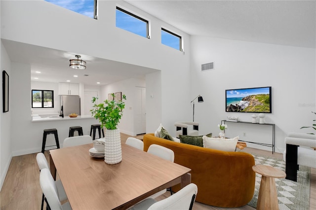 2541 Leeward Way, Winter Park, FL 32792 - dining room with light wood-type flooring, a towering ceiling, baseboards, and recessed lighting