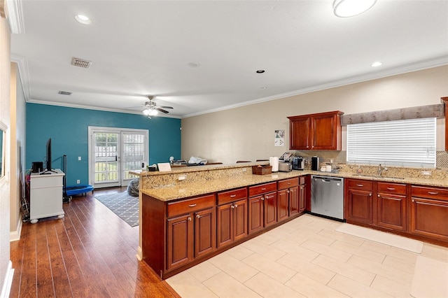 2017 W Gore St, Orlando, FL 32805 - kitchen featuring dishwasher, ceiling fan, a peninsula, a sink, and light stone countertops