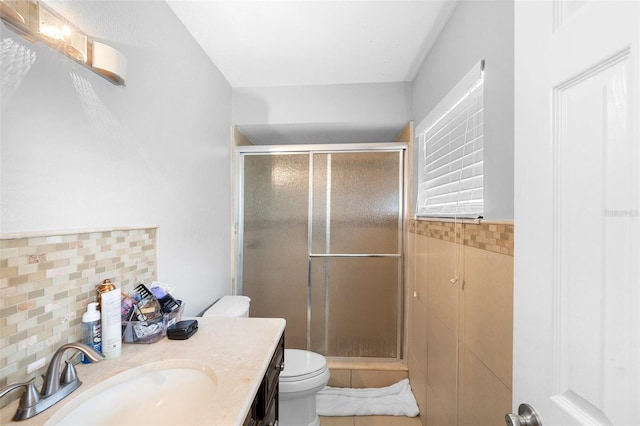 2017 W Gore St, Orlando, FL 32805 - bathroom with toilet, a stall shower, vanity, tile patterned floors, and backsplash