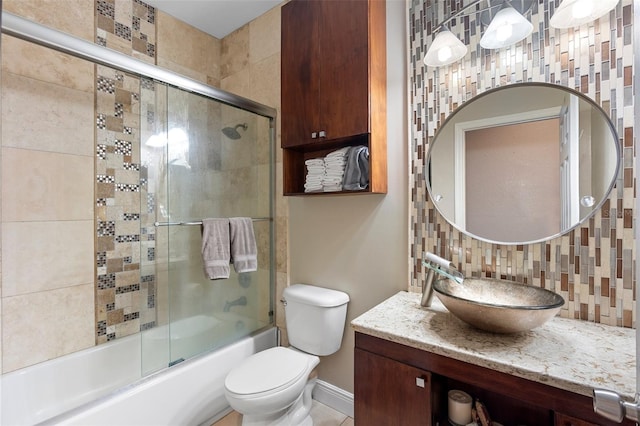 2017 W Gore St, Orlando, FL 32805 - bathroom featuring backsplash, enclosed tub / shower combo, vanity, toilet, and baseboards