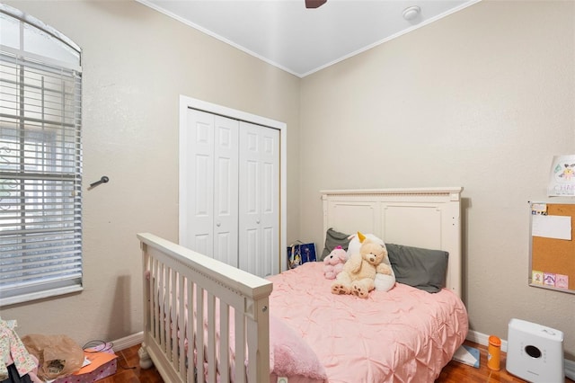 2017 W Gore St, Orlando, FL 32805 - bedroom featuring baseboards, wood finished floors, crown molding, a closet, and a ceiling fan