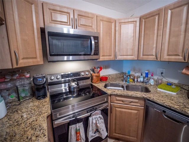 952 Courtyard Ln Unit 41, Orlando, FL 32825 - kitchen with stainless steel appliances, a sink, light stone counters, and light brown cabinets