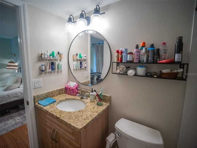 952 Courtyard Ln Unit 41, Orlando, FL 32825 - ensuite bathroom with vanity, toilet, and wood finished floors