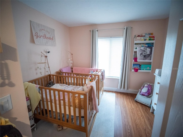 952 Courtyard Ln Unit 41, Orlando, FL 32825 - bedroom featuring wood finished floors and a crib