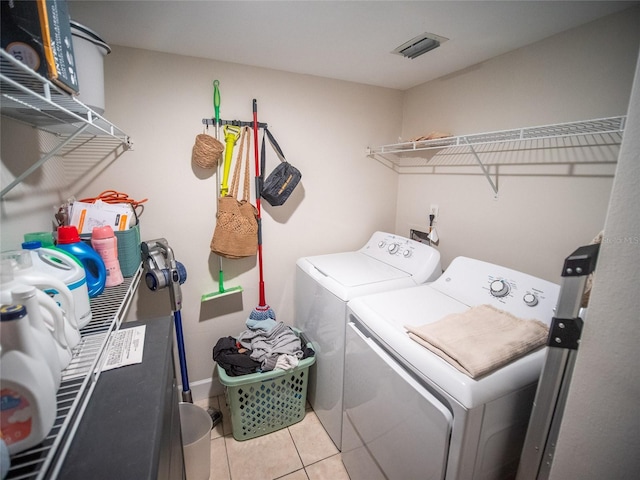 952 Courtyard Ln Unit 41, Orlando, FL 32825 - laundry area featuring washer and clothes dryer and tile patterned floors