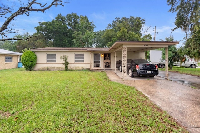 2044 W Gore St, Orlando, FL 32805 - view of front facade featuring concrete driveway, concrete block siding, a front yard, and a carport
