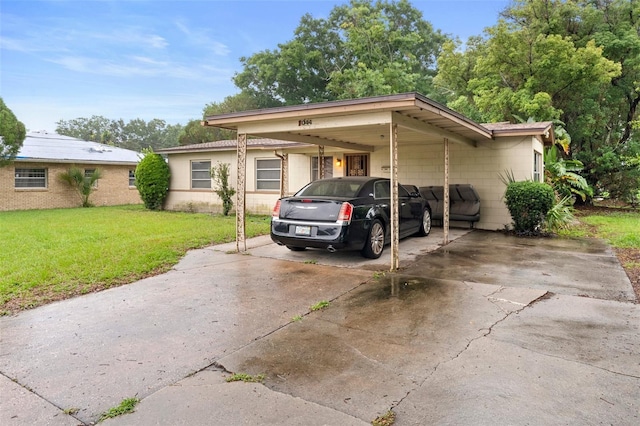 2044 W Gore St, Orlando, FL 32805 - view of front of home featuring a front yard, concrete driveway, a carport, and concrete block siding