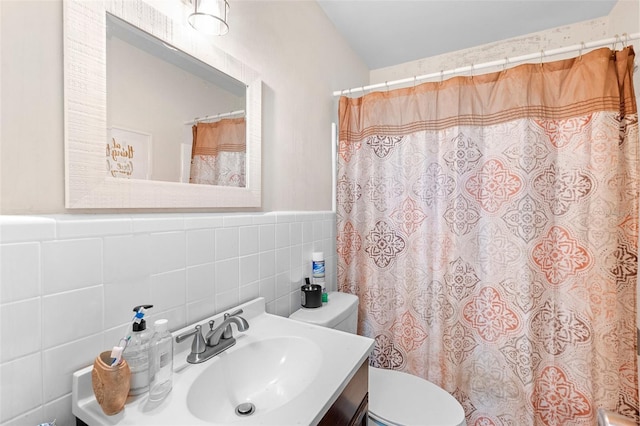 2044 W Gore St, Orlando, FL 32805 - full bathroom featuring toilet, tile walls, vanity, a shower with curtain, and wainscoting