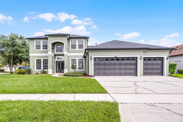 201 Hammock Dunes Pl, Orlando, FL 32828 - traditional-style home with a garage, driveway, a front yard, and stucco siding