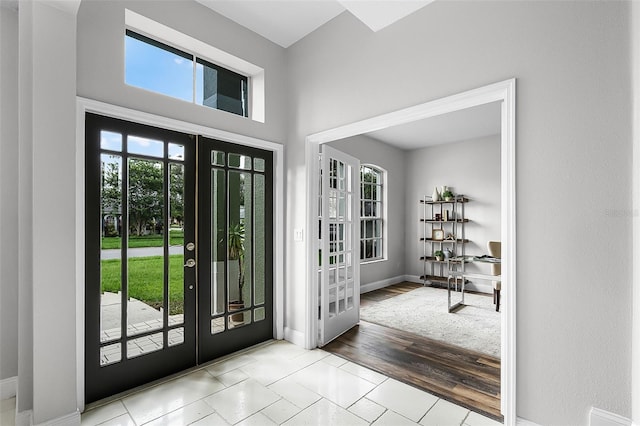 201 Hammock Dunes Pl, Orlando, FL 32828 - foyer featuring french doors, plenty of natural light, and baseboards