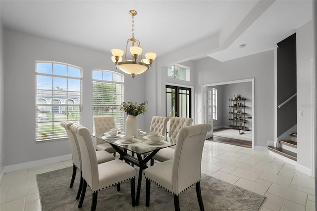 201 Hammock Dunes Pl, Orlando, FL 32828 - dining area featuring a chandelier, stairs, and baseboards