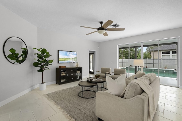 201 Hammock Dunes Pl, Orlando, FL 32828 - living area featuring ceiling fan, baseboards, a textured ceiling, and tile patterned floors