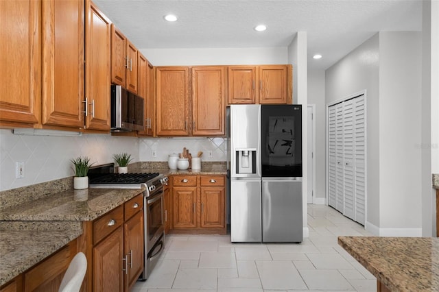 201 Hammock Dunes Pl, Orlando, FL 32828 - kitchen featuring appliances with stainless steel finishes, brown cabinets, tasteful backsplash, stone countertops, and recessed lighting