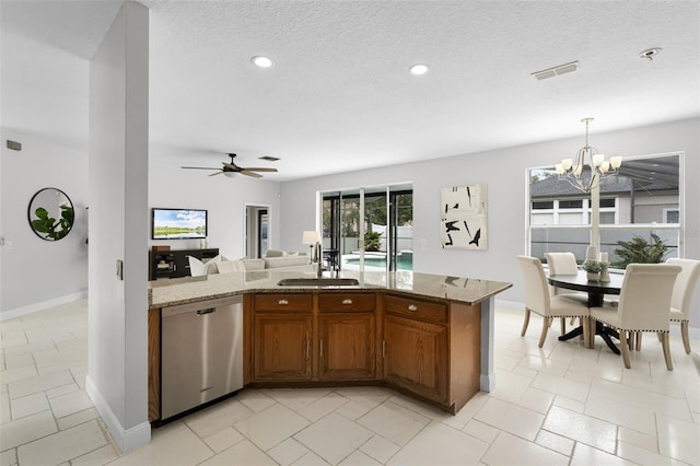 201 Hammock Dunes Pl, Orlando, FL 32828 - kitchen with dishwasher, a sink, brown cabinets, open floor plan, and light stone countertops