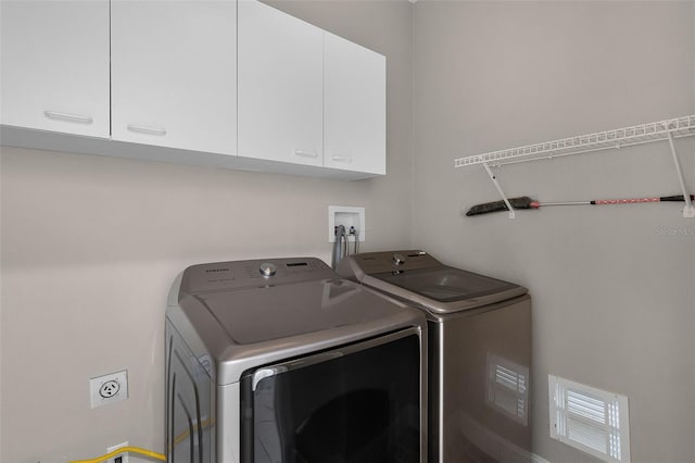 201 Hammock Dunes Pl, Orlando, FL 32828 - laundry area featuring cabinet space and independent washer and dryer