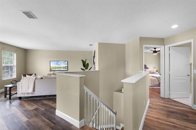 201 Hammock Dunes Pl, Orlando, FL 32828 - hall with an upstairs landing, wood finished floors, a textured ceiling, baseboards, and recessed lighting