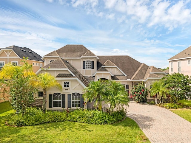 16120 Bristol Lake Cir, Orlando, FL 32828 - view of front of house with stucco siding, decorative driveway, and a front lawn