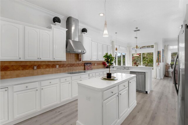 16120 Bristol Lake Cir, Orlando, FL 32828 - kitchen featuring wall chimney range hood, appliances with stainless steel finishes, a center island, a sink, and light wood finished floors