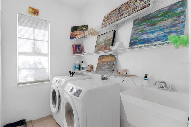16120 Bristol Lake Cir, Orlando, FL 32828 - laundry room with separate washer and dryer, healthy amount of natural light, light tile patterned flooring, and baseboards